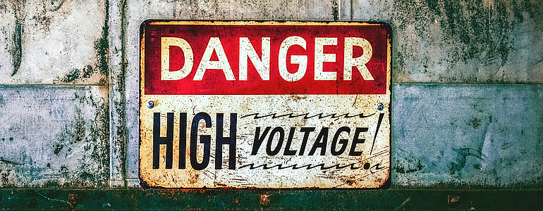 Sign reads, “Danger: High Voltage!”